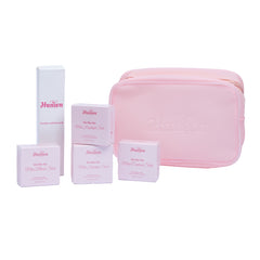 Set of pink Haneen skincare products including a pouch and boxes on a white background
