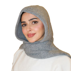 Woman wearing a gray hooded scarf on a white background