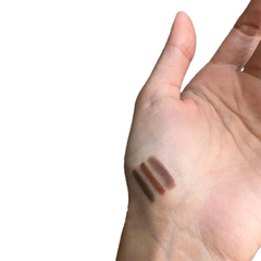 Two brown makeup swatches on a person's hand against a white background