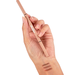 Hand holding a makeup pencil with 'Janssen' branding, showing color swatches on the skin.