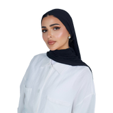 Woman wearing a black hijab and white shirt on a white background