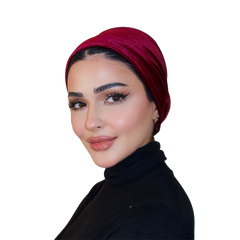 Woman wearing a red headscarf and black outfit on a white background