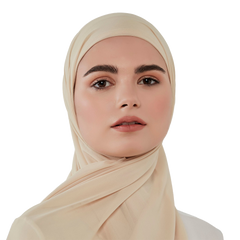 Woman wearing a beige hijab against a white background