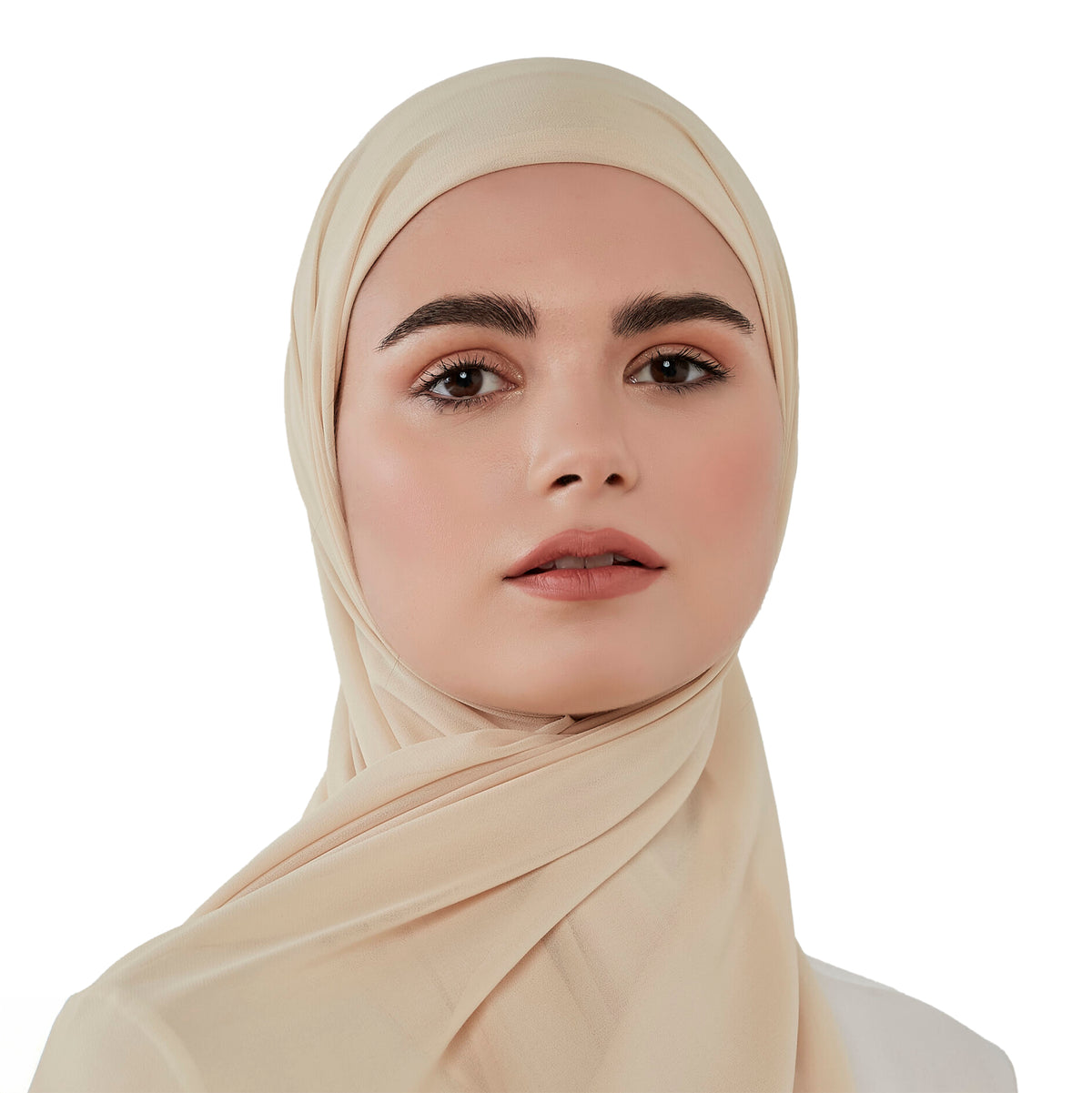 Woman wearing a beige hijab against a white background