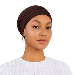 Woman wearing a brown headscarf on a white background