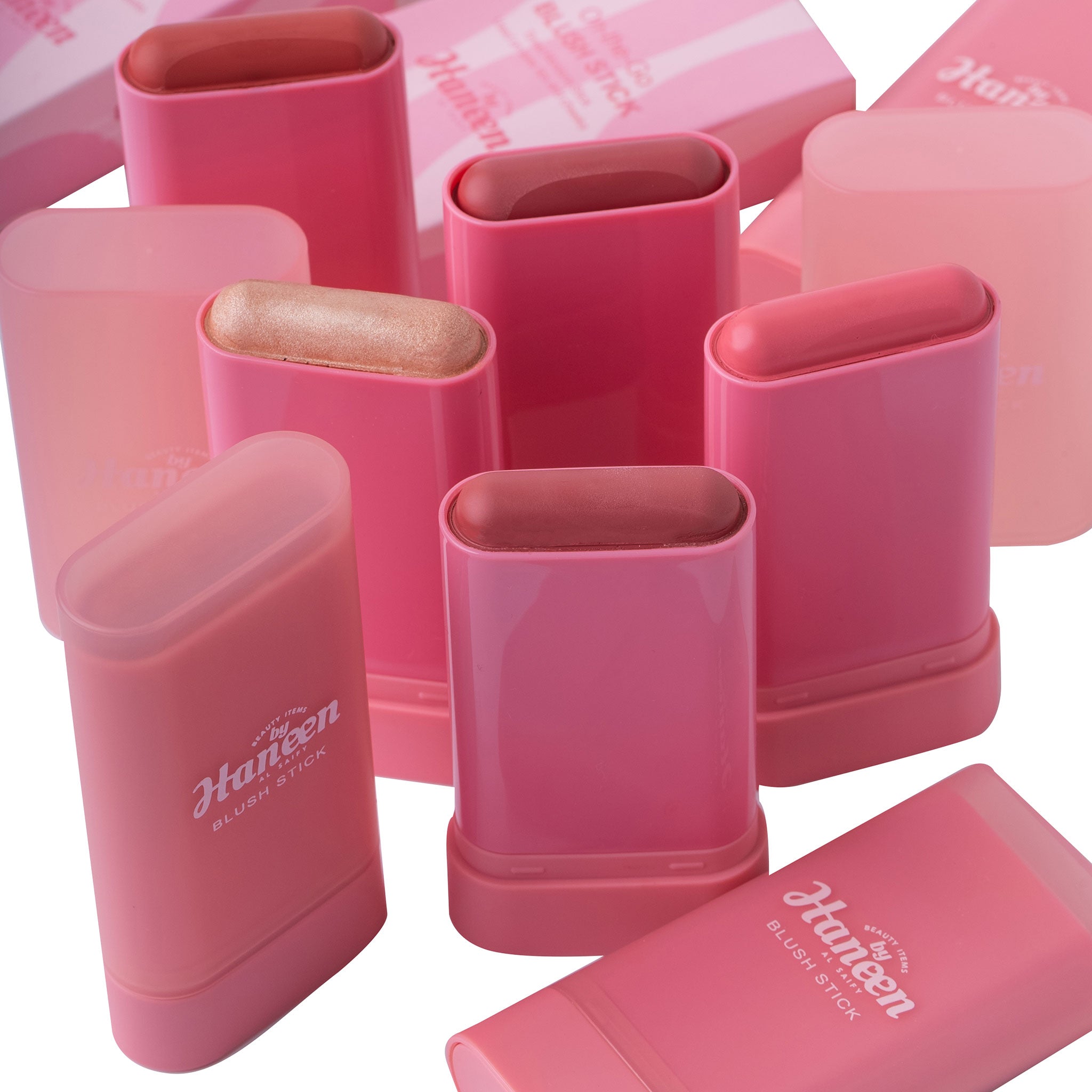 Pink Huppen lip balm containers on a white background