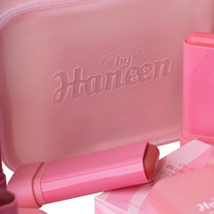 Pink makeup case with 'Haneen' branding and various pink makeup items.