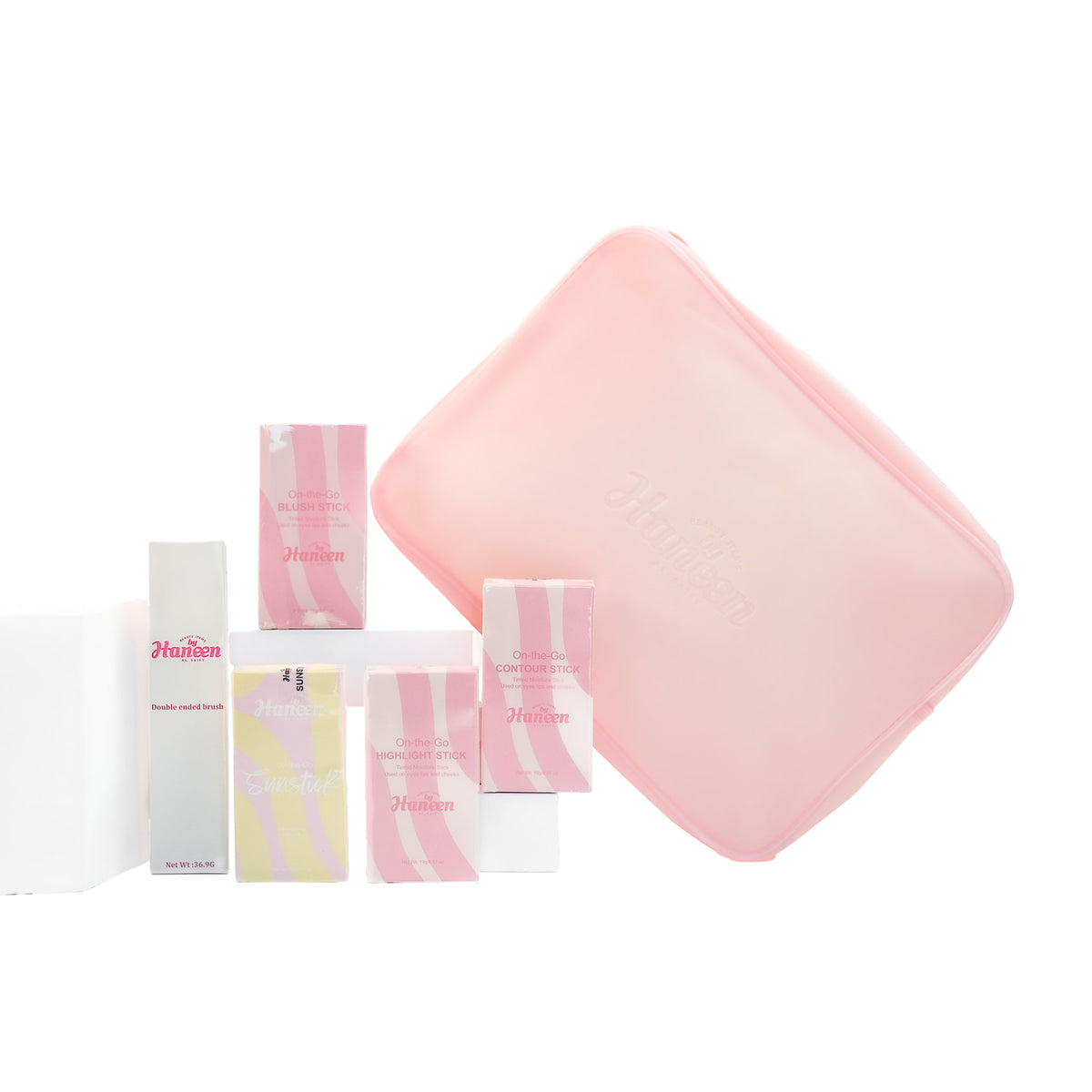 Set of pink and white skincare products with a pink square item on a white background
