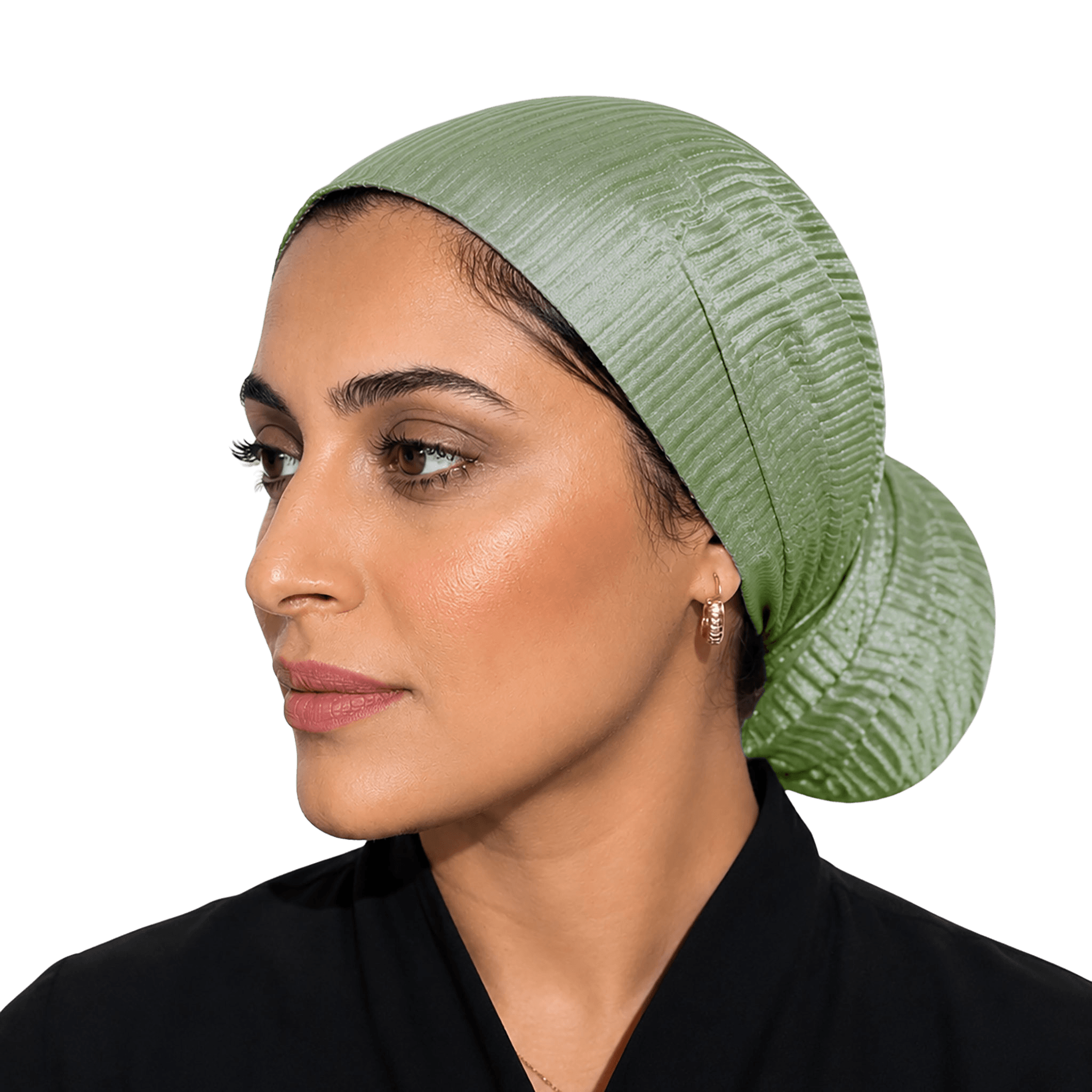 A woman shown in profile wearing a textured sage green head covering, photographed against a solid black background.