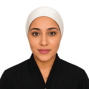 A woman wearing a white ribbed hijab and a black top, photographed against a solid black background.