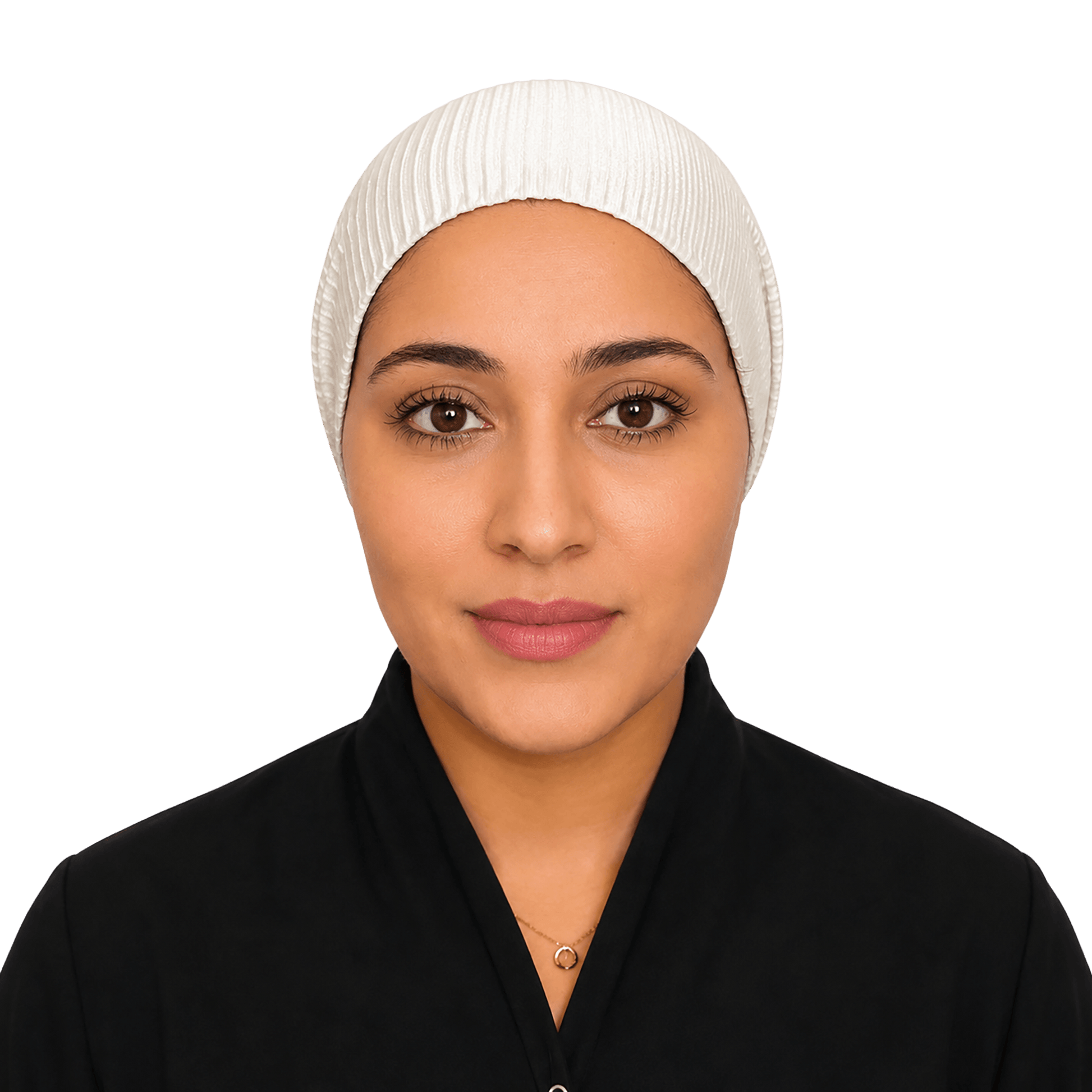 A woman wearing a white ribbed hijab and a black top, photographed against a solid black background.