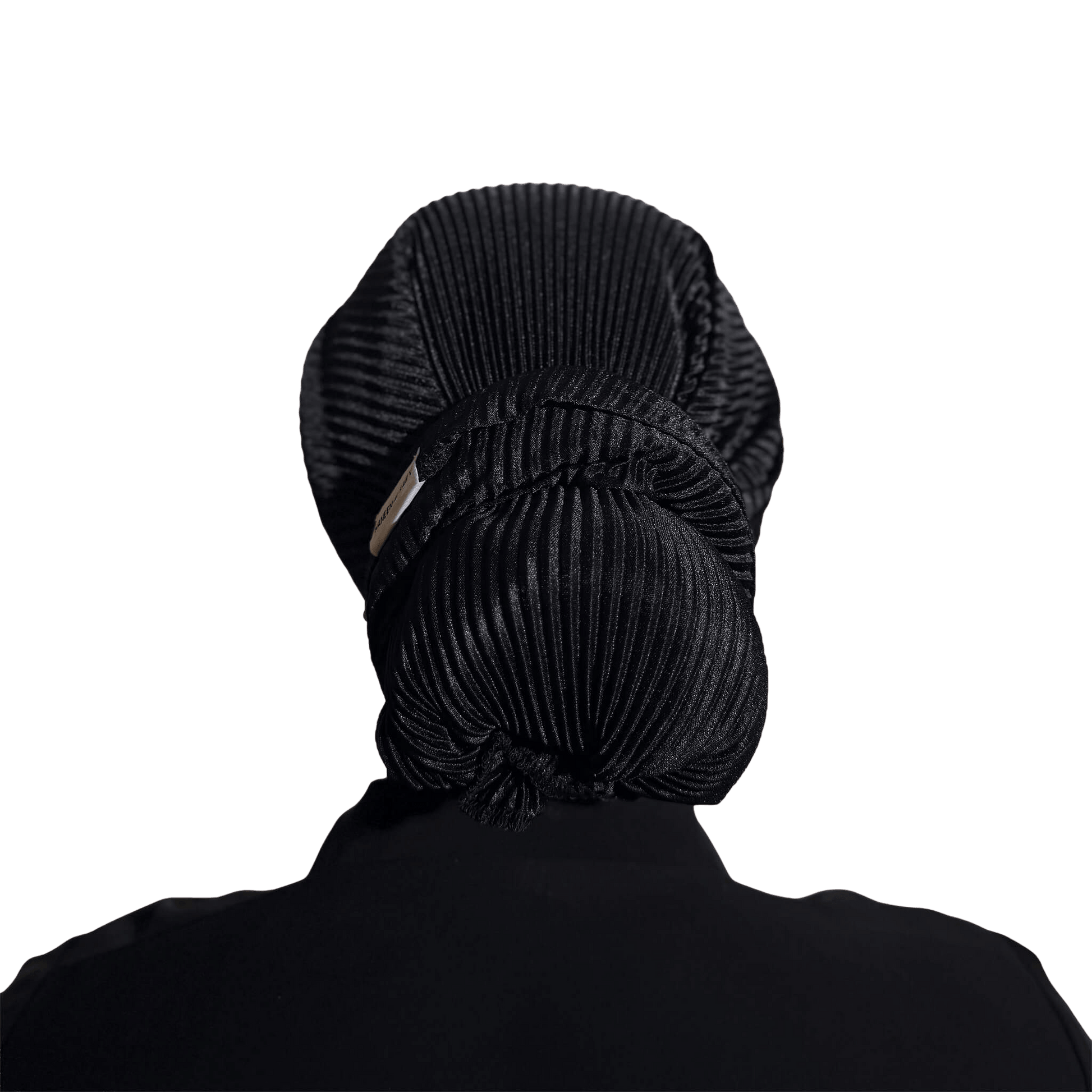 A black pleated hair bun headwrap or hair net shown from the back, worn by a person with their hair styled in a large bun, against a solid white background.