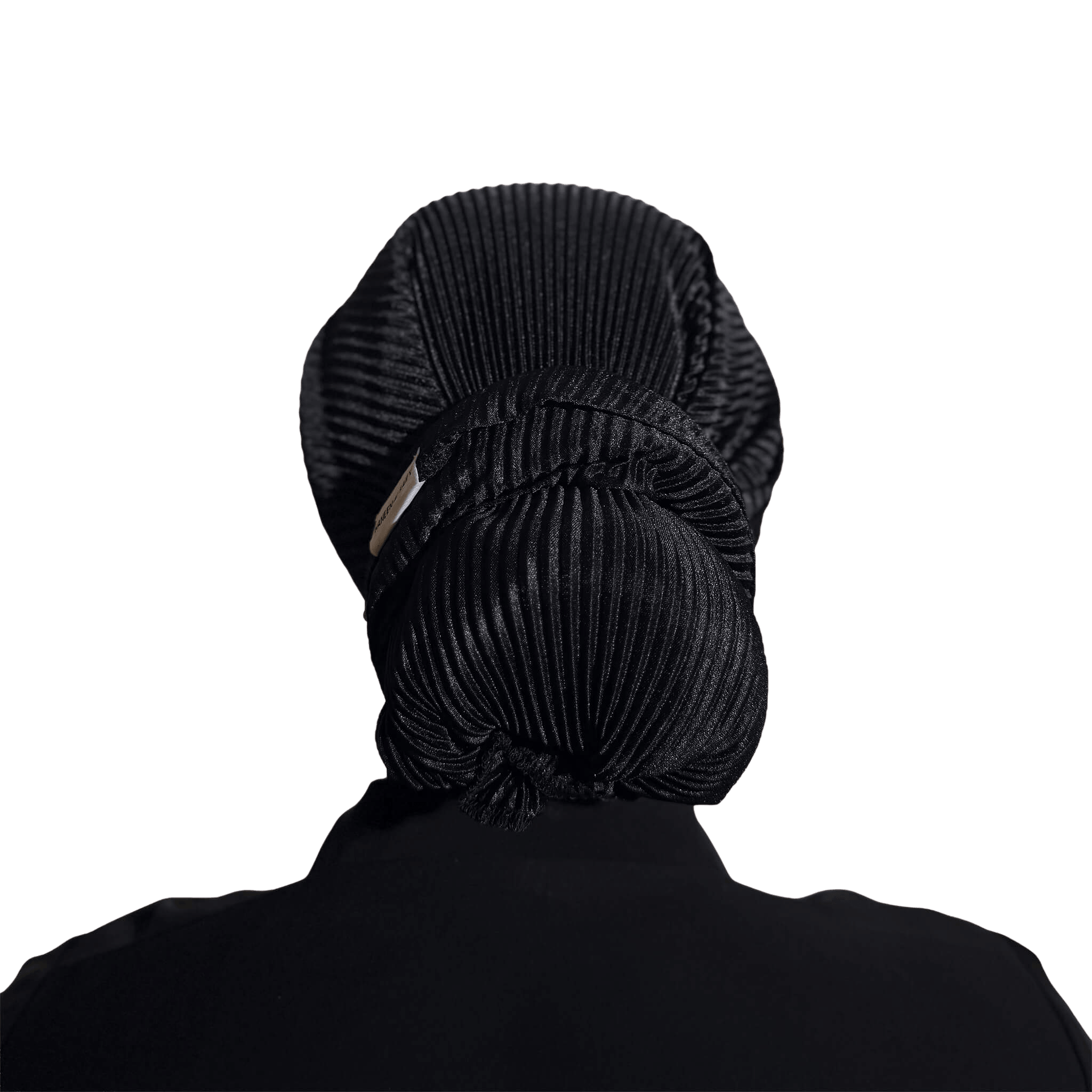 A black pleated hair bun headwrap or hair net shown from the back, worn by a person with their hair styled in a large bun, against a solid white background.