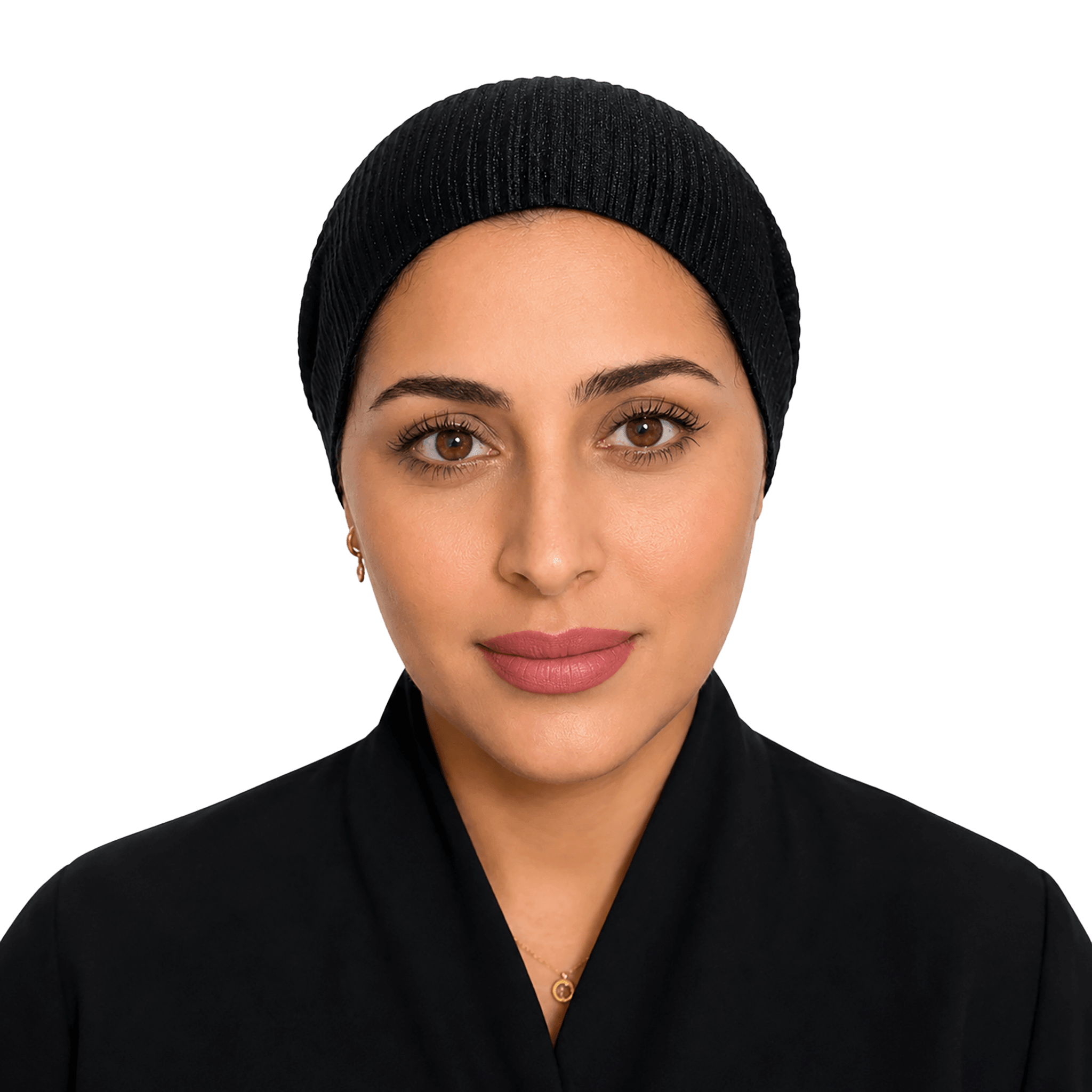 A woman wearing a black ribbed knit hijab and a black collared garment, photographed against a solid black background.