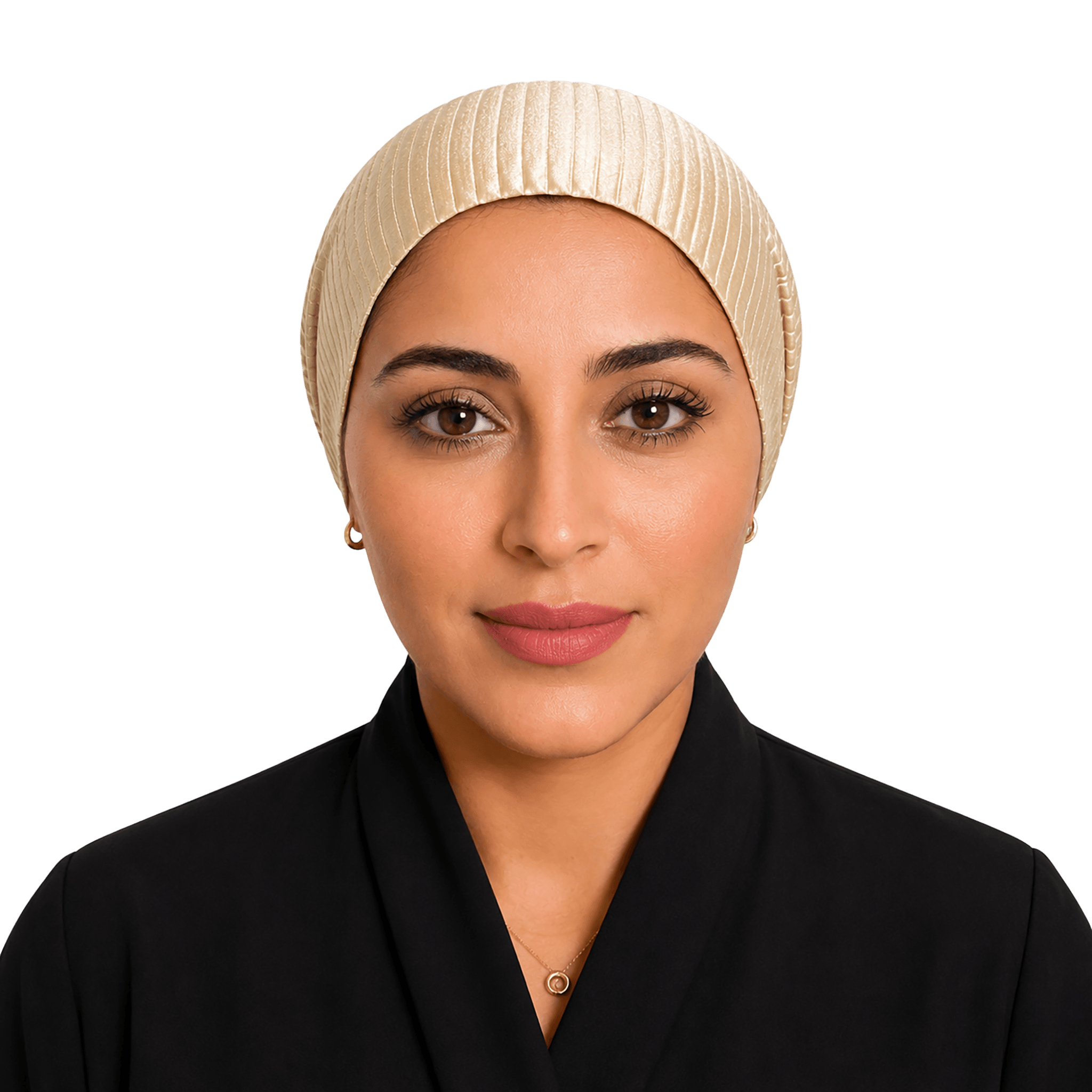 A woman wearing a cream-colored pleated hijab and a black collared garment, photographed against a solid black background.