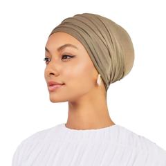 Woman wearing a beige headscarf on a white background