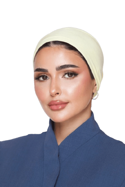 Woman wearing a light yellow headscarf and blue outfit without background