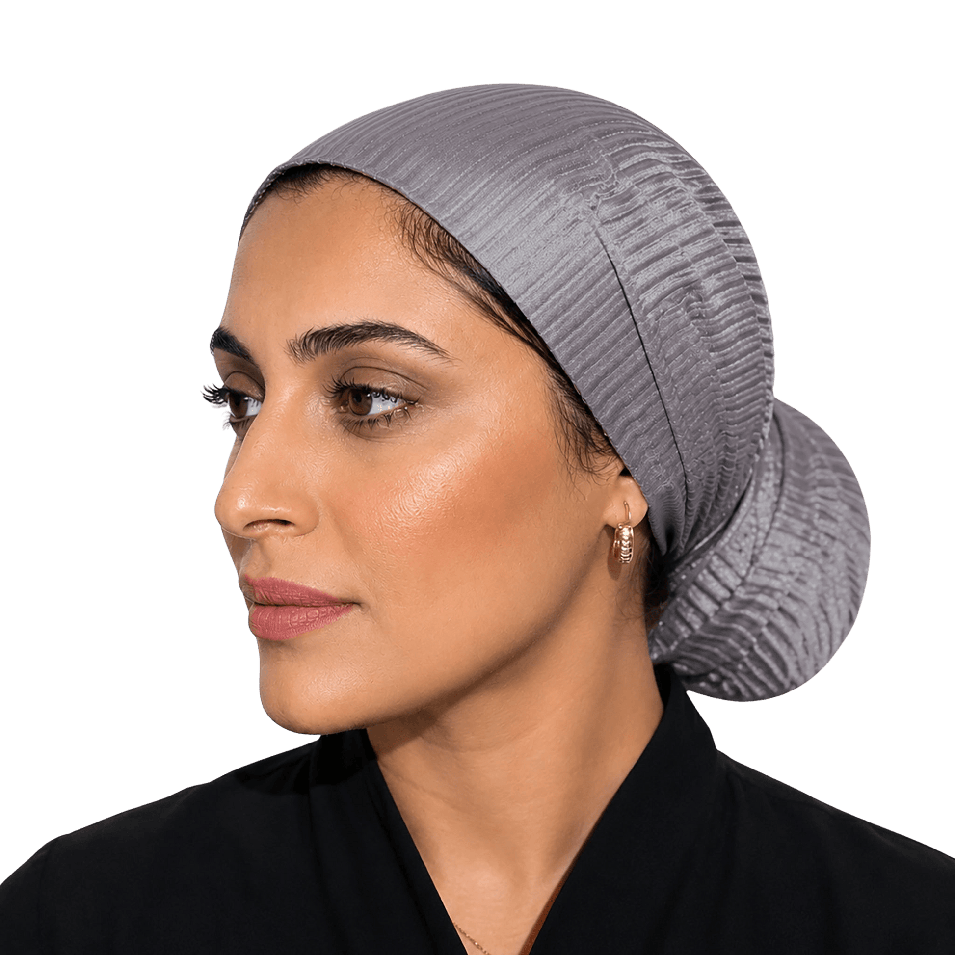 A woman wearing a textured, pleated gray hijab or skullcap, shown in profile against a solid black background.