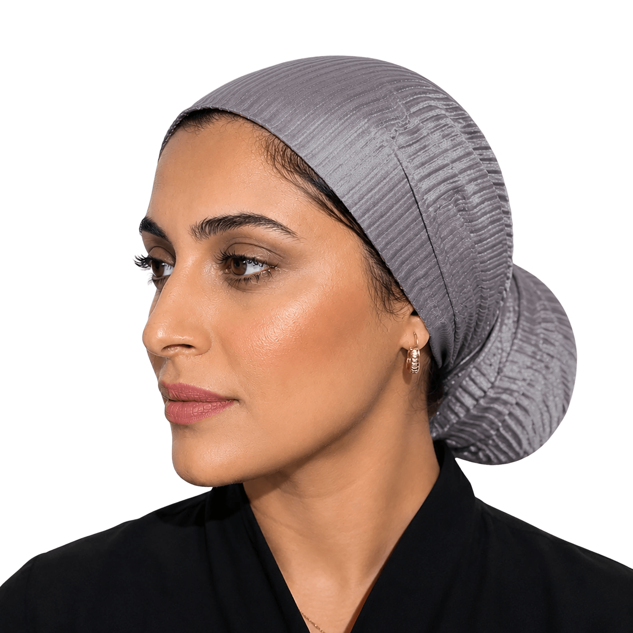 A woman wearing a textured, pleated gray hijab or skullcap, shown in profile against a solid black background.