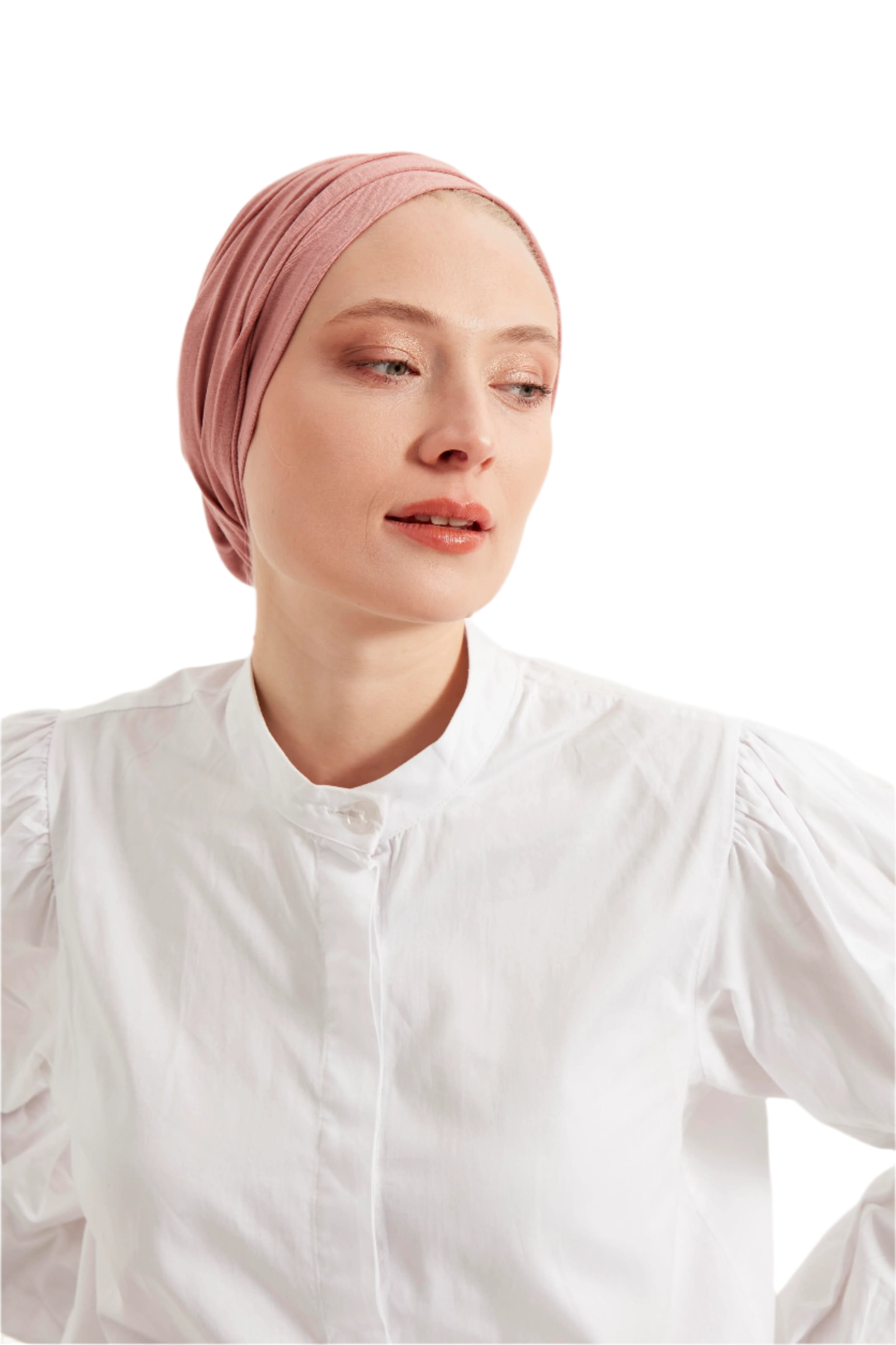 Woman wearing a pink headscarf and white shirt against a light background
