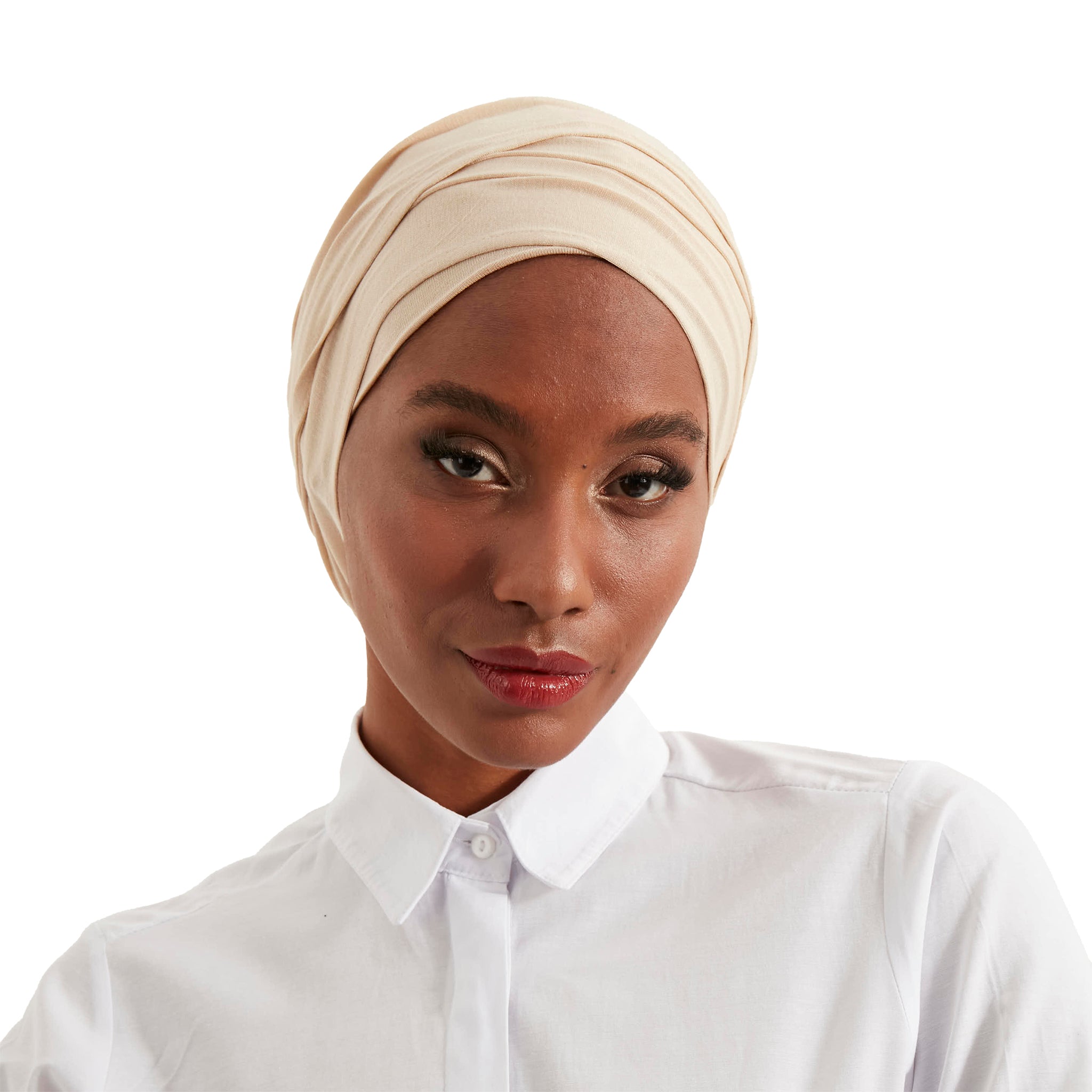 Woman wearing a beige headscarf and white shirt on a white background