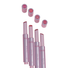 Set of pink lipsticks with open caps on a white background