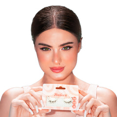 Woman holding a package of false eyelashes with a white background