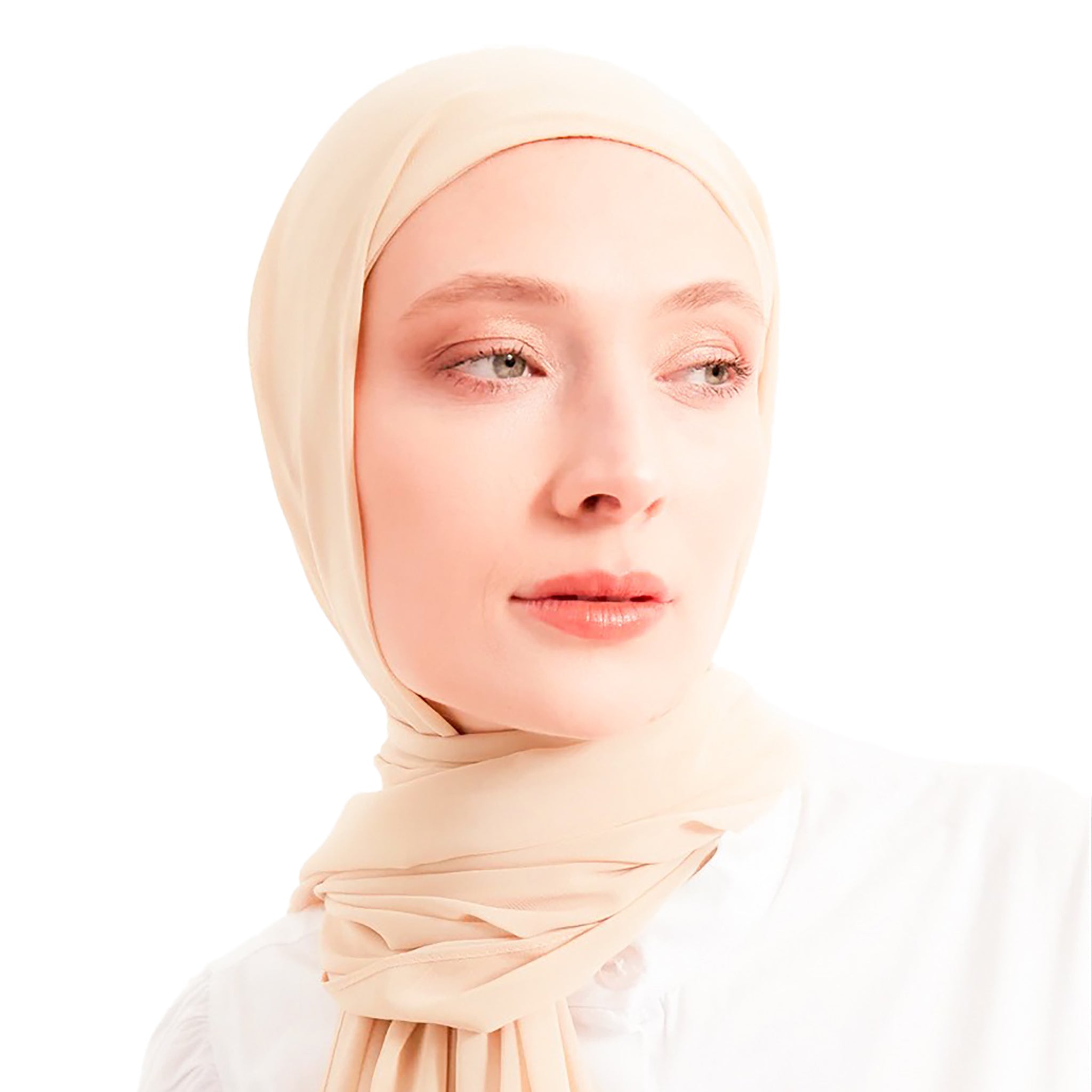 Woman wearing a beige hijab against a white background