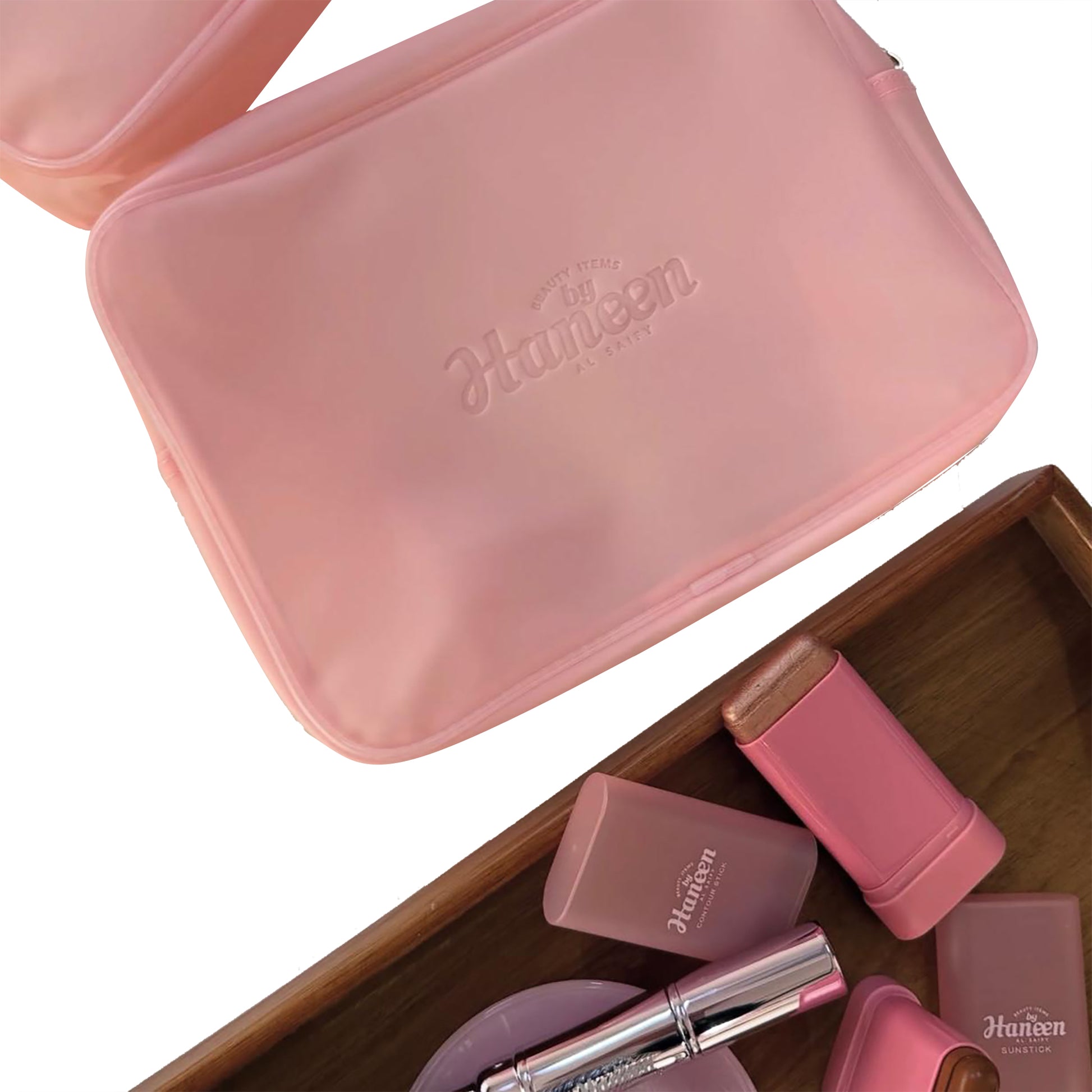Pink cosmetic bag with 'Haven' branding, containing various pink makeup items on a white background.