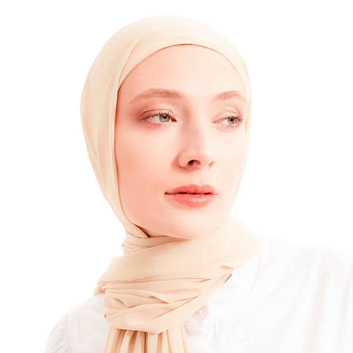 Woman wearing a beige hijab against a white background