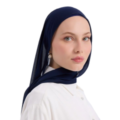 Woman wearing a navy hijab and white shirt on a white background