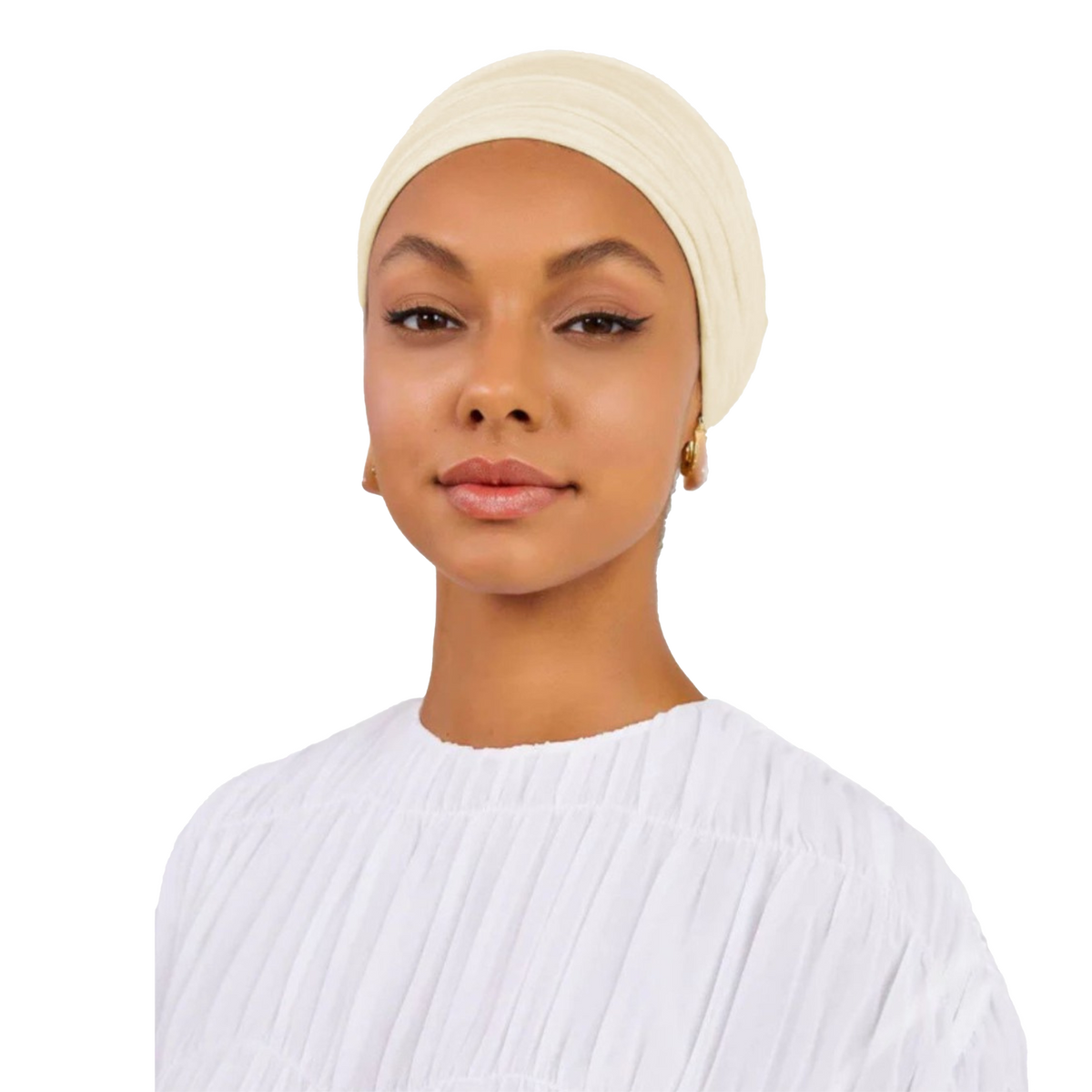 Woman wearing a beige headscarf and white top on a white background