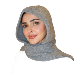 Woman wearing a gray hooded scarf on a white background
