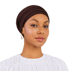 Woman wearing a brown headscarf on a white background