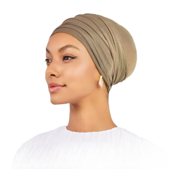 Woman wearing a beige headscarf on a white background