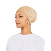 Woman wearing a beige headscarf on a white background