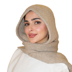Woman wearing a beige hijab on a white background