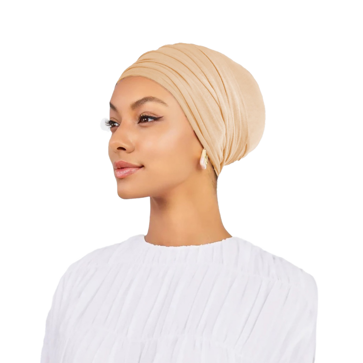 Woman wearing a beige headscarf on a white background