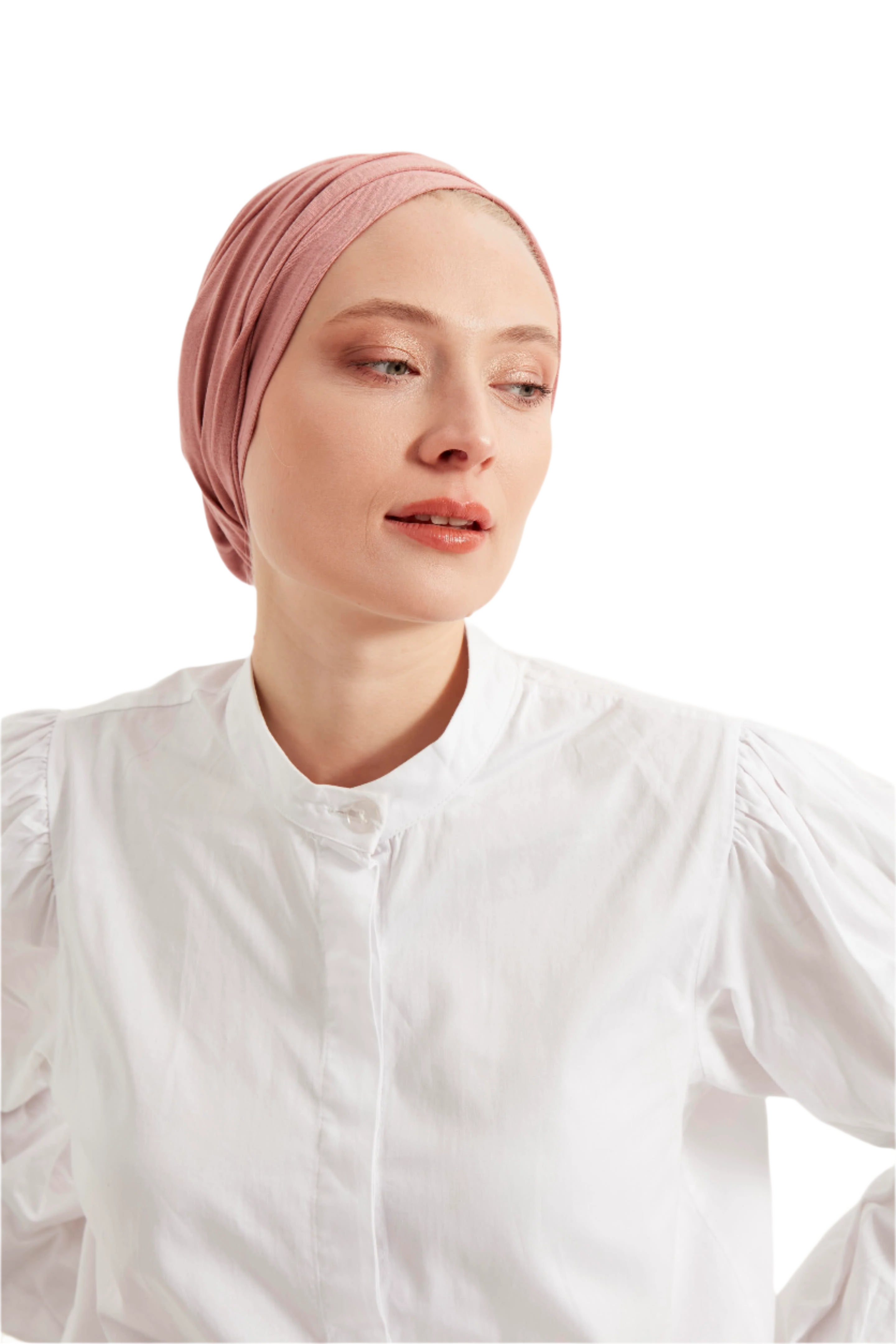 Woman wearing a pink headscarf and white shirt against a light background