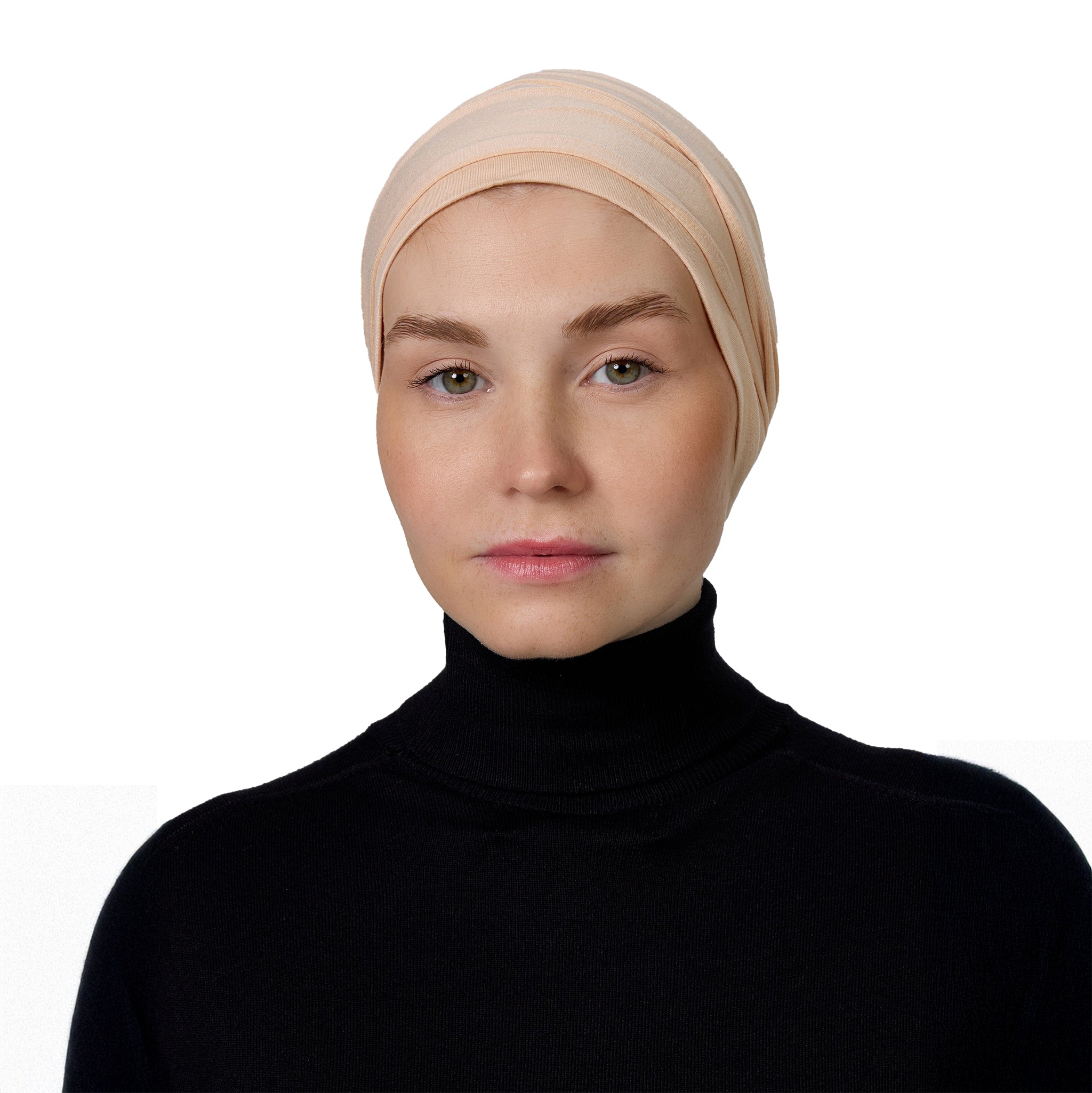 Woman wearing a beige headscarf on a white background