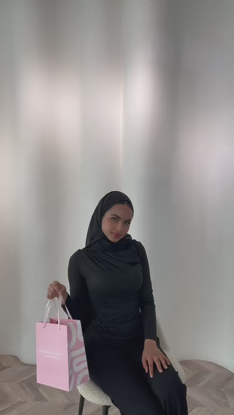 Load video: Woman wearing a beige hijab against a white background